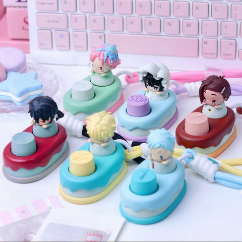 A collection of six individual mechanical keycaps, each featuring a "baby" version of an Alien Stage character mounted on a colorful, cake-themed base.