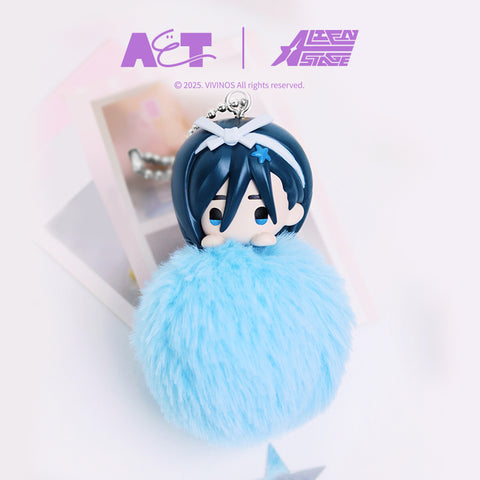 Alien Stage Sua plush keychain designed with a blue-haired chibi character head resting on a sky blue fuzzy pom-pom body. The figure includes a white hair accessory, silver ball chain attachment, and is styled in a bright studio scene with soft pastel accents.