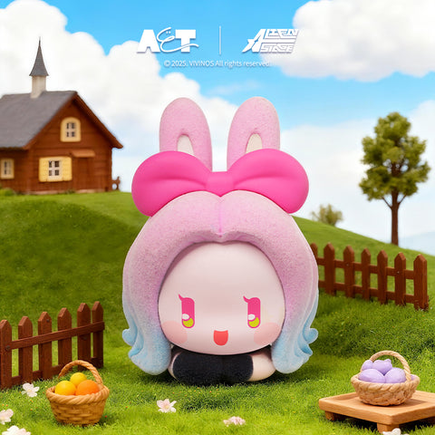 A soft pink and blue gradient rabbit figure with a large pink bow, kneeling in a garden next to a basket of colorful eggs.