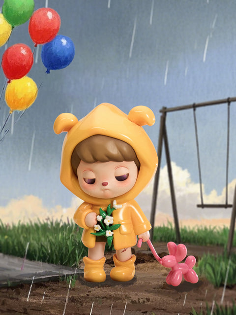 A childlike figure in a bright yellow raincoat with bear-like hood stands in gentle rain, holding white flowers in one hand and pulling a pink balloon dog with the other. Their closed eyes and faint blush convey a quiet sadness, as colorful balloons float in the gray sky, blending innocence and somber fairytale tones.