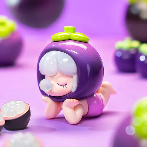 This image features an adorable collectible figurine from the Baby Nanci Fruits Series Blind Box collection. The character has a serene expression with closed eyes and rests on its hands in a relaxed pose. It wears a glossy, deep purple mangosteen-inspired headpiece with a green leafy stem on top. The figure’s short, white hair contrasts beautifully with the rich purple tones. The pastel purple background is adorned with small, mangosteen-like decorations.