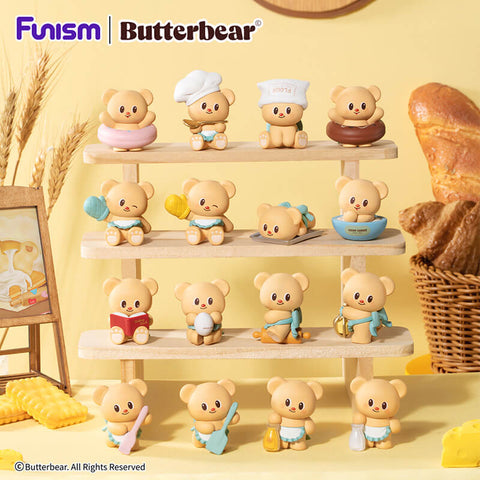 Full series display of Butterbear “Baked With Love: Cubby Face” blind boxes, featuring all collectible bears across three tiers. Each figure showcases a unique baking theme, from oven mitts and cream cheese tubs to spatulas, honey jars, and chef hats, highlighting playful variety and adorable design details.