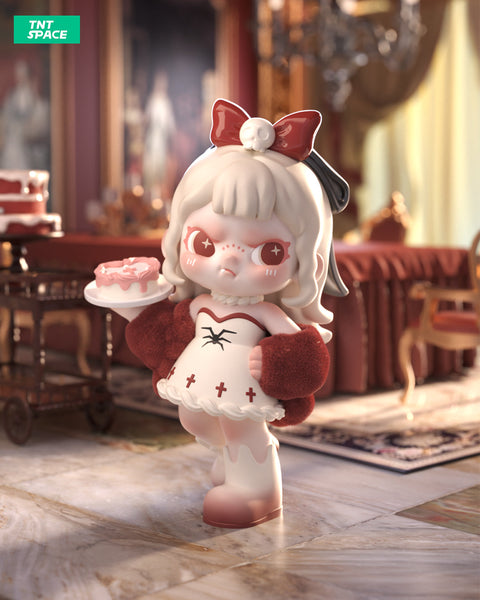 A 3D-rendered Dora figurine with a gothic-sweet theme stands in an opulent room with chandeliers and rich red decor. The character has white hair, red eyes with star-shaped pupils, and wears a red bow with a skull accent. Dressed in a white and red dress with a spider motif, fluffy red sleeves, and white boots, it holds a plate with a pink dessert. The character's expression is slightly pouty, adding to its mischievous charm. A dessert cart and cakes are visible in the background.