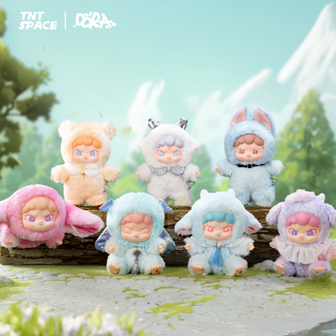 Six pastel plush figures from TNT SPACE × DORA stand and lounge on a log in a bright garden. Each doll wears a fluffy creature hood—bear, horned spirit, bunny, winged sprite, lamb, and ruffled lamb—with pink or blue hair and starry eyes, against a mint sky with mountains.