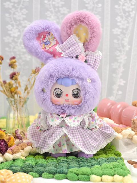The secret Park Rabbit chaser is a lavender Doubao with oversized rabbit ears, one lined with a detailed printed patch. It wears a layered purple gingham dress with floral accents and pastel bows, blending plush textures with whimsical fashion for a rare 400% collector’s piece.