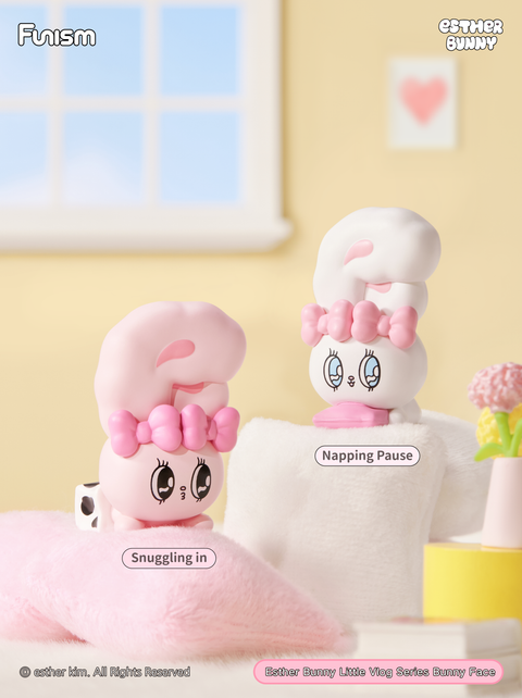 A bedroom-themed setup with two bunnies resting, one snuggling into a fluffy pillow and the other napping peacefully on a soft cushion. The warm, pastel decor emphasizes rest and relaxation.