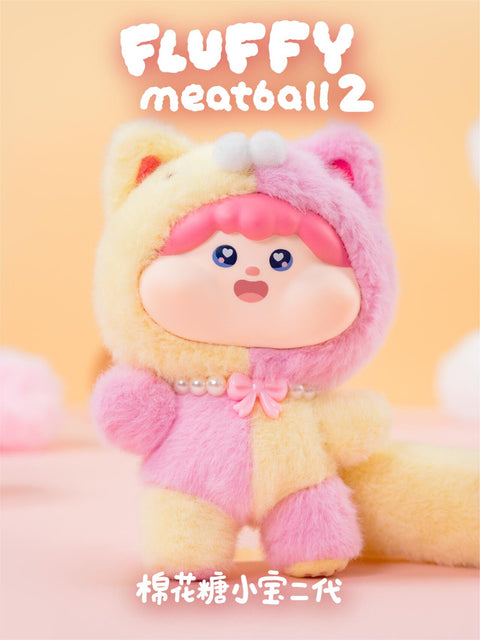 Pink and yellow kitty plush wearing a two-tone fluffy outfit with pearl bead necklace and pink bow. The wide-eyed face and long striped tail enhance its playful kitten character, adding extra charm to the collection.