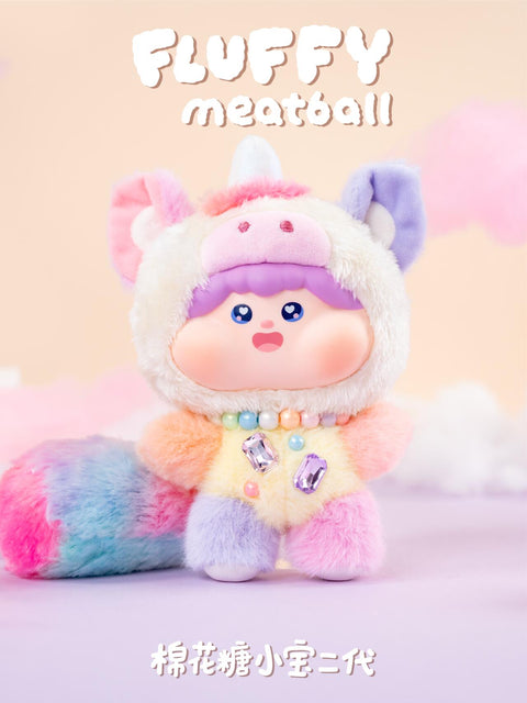 Secret Unicorn plush with pastel rainbow body, fluffy gradient tail, and white hood featuring a unicorn horn and ears. Decorated with a beaded necklace and sparkling gem accents, this rare chaser figure radiates fantasy charm and dreamy collectible appeal.