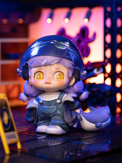 KO Challenger figure from the Kokosa KO Girls Series wears overalls and a helmet with translucent visor, holding a small shark companion. Her bright yellow starry eyes show determination, while the industrial neon-lit background adds intensity. The design conveys courage and resilience against challenges.