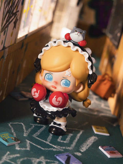 KO Sad figure portrays a blonde girl in a frilly black-and-white maid dress with boxing gloves. A small gray cat rests atop her head as she wanders a graffiti-filled school hallway with scattered books. Her teary eyes, bandages, and defensive stance highlight themes of sorrow, endurance, and fighting spirit.