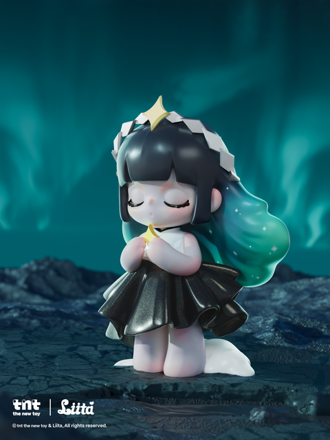 A figurine with black hair fading into teal and decorated with small star-like speckles stands on a dark rocky surface beneath swirling blue-green aurora lights. She holds a small glowing star with both hands, eyes closed, wearing a black shimmering dress that reflects the cool, moody atmosphere around her.