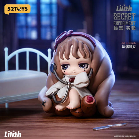 A figurine from the "Lilith: Secret Experiment" blind box series titled "Doll Research" features a solemn character sitting curled up with a stethoscope draped around her neck. She has long brown hair, a stitched-up teddy bear body, and wears a white coat with a red bow. The setting includes a small hospital bed and a scalpel on the floor, creating a moody, gothic lab scene that blends eerie medical themes with doll-like innocence.
