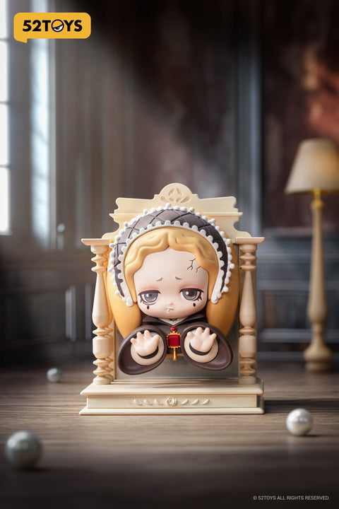 Close-up of the “Mirror of the Apocalypse” figure from 52TOYS’ Lilith: The Century of Mary series. The character is framed in a cream-colored structure resembling a gothic mirror or confessional booth, with pale blonde hair, cracked skin, and a sorrowful expression. She wears a dark robe with a red pendant and extends her hands forward. The background features a dimly lit room with wood floors and scattered pearls, enhancing the somber, antique atmosphere.