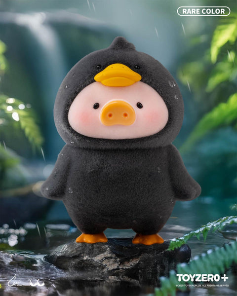 A rare LuLu the Piggy variant in a black duck costume with orange webbed feet and a yellow duck face hood. It stands in a misty, rainy forest scene on a wet rock.