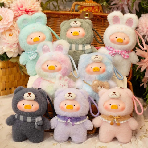 A collection of adorable plush keychains from the "LuLu The Piggy: Joyful Time Series" is displayed in a cozy picnic setting. Each plush features LuLu the Piggy dressed in soft, fuzzy animal costumes, including bears, bunnies, and pastel-hued critters. Some wear scarves or bows for added charm. The warm wicker basket, floral decorations, and delicate lace tablecloth create a whimsical, cottagecore atmosphere that enhances the plush toys' sweet and huggable appeal.