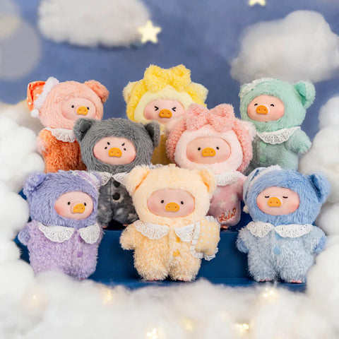 A group of eight plush pigs in various pastel bear suits stands in a cloud-like setting with a starry sky backdrop. Colors include peach, gray, yellow, mint, lavender, cream, pink, and blue. Each figure features a lace collar and fuzzy textures. The arrangement highlights the full Dreaming Wonderland series.