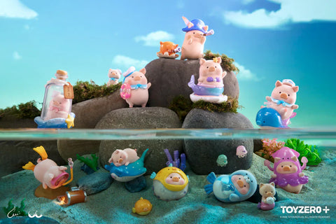 Full display image of the LuLu The Piggy Ocean Series blind box by 52TOYS and ToyZero+. Adorable LuLu pig figures are posed above and below a watery diorama, blending rocky islands with a colorful underwater world. Each figure features a unique ocean-themed design—some floating with sea creatures or riding dolphins, while others wear diving suits or sit in bottles. The scene showcases all 8 regular designs, 1 secret, and 1 super secret figure in a magical seaside adventure.
