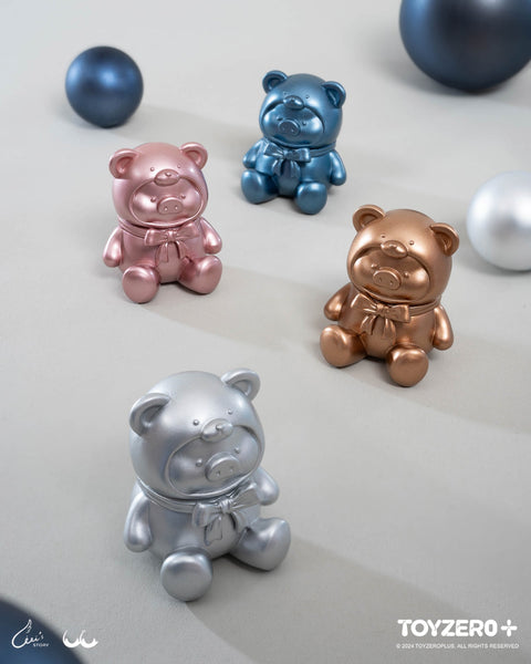 Four metallic teddy piggies in rose gold, blue, bronze, and silver sit scattered with matching spheres. Their shiny finishes highlight the mysterious twilight theme.