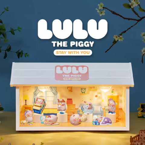 A display of collectible figurines from the "Lulu the Piggy: Stay With You" blind box series is shown inside a miniature, warmly lit dollhouse-style room. The scene features various pig characters engaging in cozy nighttime routines—reading, sleeping, cuddling, and playing. Above the house, the title “Lulu the Piggy: Stay With You” is prominently featured in playful fonts. The background includes a night sky with flowering tree branches, enhancing the comforting, whimsical theme.