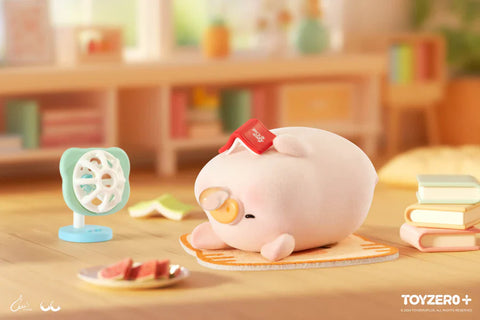 In this relaxed and whimsical scene from the “Lulu the Piggy: Stay With You” blind box series, a piggy figurine naps on a soft mat . A tiny fan blows nearby while a plate of watermelon slices rests on the floor, capturing the essence of a lazy, warm day. Surrounded by pastel books and cozy cushions in a warmly lit room, the setting radiates a peaceful, comforting atmosphere perfect for an afternoon siesta.