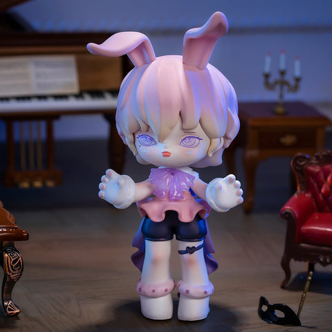 A 3D-rendered MISYA Incredible Mansion Series figure stands in a dimly lit, vintage-style room. The character has pastel pink and purple hair, bunny ears, and glowing purple eyes with an eerie, vacant expression. Dressed in a frilly pink top, dark shorts, and a flowing cape, it appears to be reaching forward with ghostly white hands. A grand piano, antique furniture, and a masquerade mask on the floor enhance the mysterious, gothic atmosphere of the scene.