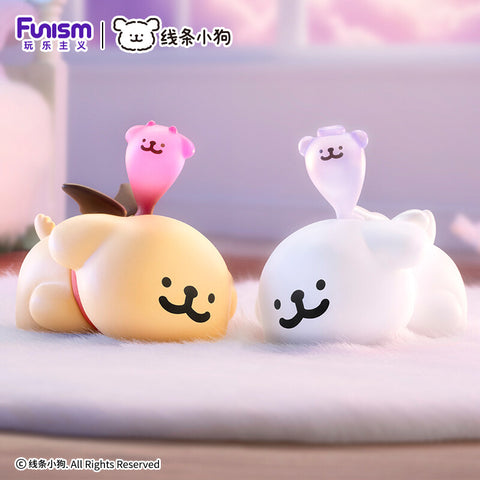 Two pups lying down with small translucent pink and purple "dream" spirits floating above their heads.