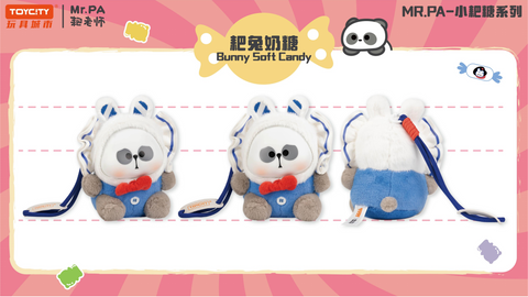 A bunny-themed plush of Mr. PA in blue overalls with a red bow tie, fluffy white hood, and long rabbit ears. The plush has rounded grey paws, stitched button detail, and comes with a blue strap for a sweet candy-inspired look.