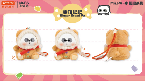 A plush design of Mr. PA as Ginger Bread Pa, dressed in a warm tan outfit with button details and a white fur hood. The figure has a red scarf, soft rounded paws, and a small strap, styled to resemble a gingerbread treat.