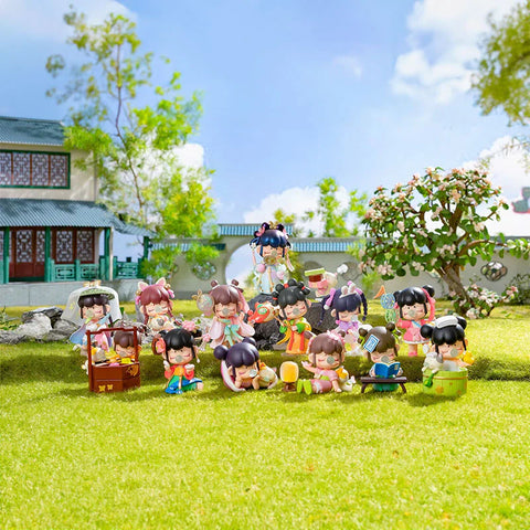 A charming collectible figurine set from the "Nanci Blooming Girl" series features multiple characters in traditional Chinese-inspired outfits, engaging in various leisurely activities. Set against a lush garden backdrop with a classical-style house, the figures display intricate details, including fans, books, and musical instruments. The vibrant colors and delicate expressions bring a serene, nostalgic feel, evoking the beauty of ancient Chinese culture in a whimsical, playful scene.