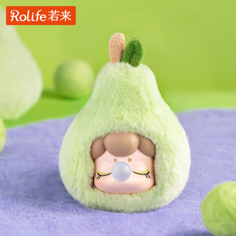A pear-shaped Nanci Fruit Mood plush with a fuzzy light green texture and two tiny felt leaves. The doll’s peaceful face shows closed eyes, long lashes, and a bubblegum bubble at the lips. Its unique tapered fruit shape adds playful variety to the dreamy plush series collection.