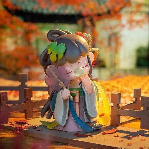 Nanci walking in front of a temple during a sun set. She's holding a big leaf in her right hand.