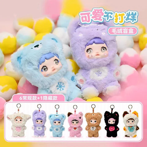 A promotional image for the "Nommi: Loveliness Never Ends" plush blind box series, featuring two plush figures in pastel bear costumes with expressive doll faces, set against a background of colorful cotton balls. Below them is a lineup of 6 regular and 1 hidden character designs, each in a unique animal-themed outfit with keychain loops. The aesthetic is soft, cute, and whimsical, emphasizing the collectible charm and cuddly appeal of each plush figure.