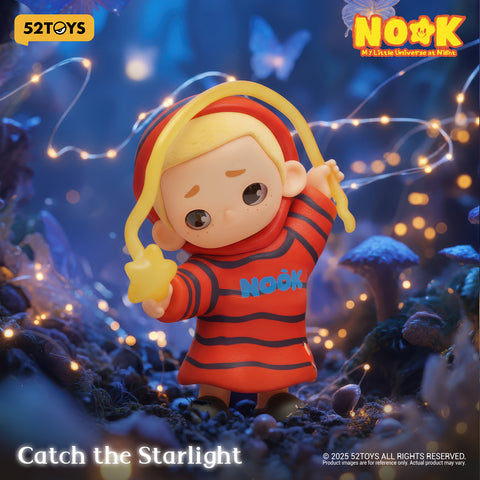 Nook in a red and black striped oversized sweater, holding a yellow star suspended from a flexible translucent cord.