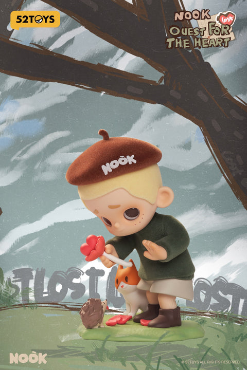 A figure from the 52TOYS Nook “Quest for the Heart” blind box series features a boy with blonde hair wearing a fuzzy brown beret labeled “NOoK” and a green outfit. He is gently offering a red heart-shaped flower to a small hedgehog while a fox companion stands nearby. The background shows stylized trees and the word “LOST” partially visible.