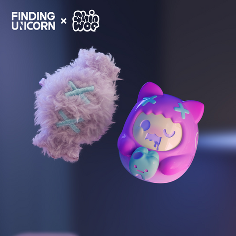 Two matching figures float against a dark blue gradient background. On the left is a soft purple candy-shaped plush with blue stitched X marks. On the right is a glossy purple cat vinyl figure with pink hood and blue X marks, holding a pale blue candy featuring a small face.