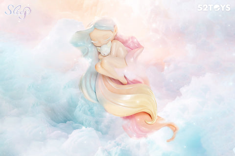 This 52Toys “Sleep: Life of Fantasies” figurine, titled “Embrace,” features a gentle character peacefully floating in a pastel dreamscape of soft pink and blue clouds. With closed eyes and flowing multicolored hair, she lovingly cradles a small sleeping animal in her arms, evoking warmth, comfort, and quiet affection.