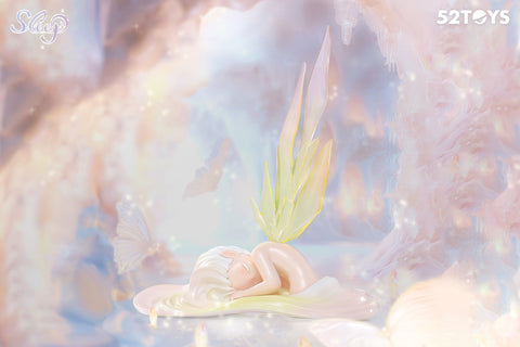 A rare secret figurine from the 52Toys “Sleep: Life of Fantasies” series depicts a delicate, fairy-like character sleeping peacefully on a soft, petal-like surface. Her translucent yellow wings rise gently behind her as she rests in a glowing pastel cave filled with butterflies and crystal-like formations, creating a serene, dreamlike atmosphere.