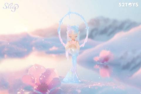 A secret figurine from the 52Toys “Sleep: Life of Fantasies” series titled “Snowmelt Season” features a delicate character with icy blue hair and fox-like ears. She stands gracefully with eyes closed, holding a heart-shaped object, encircled by a translucent ring of icicles. The dreamy pastel landscape with melting snow and blooming flowers captures the transition from winter to spring.