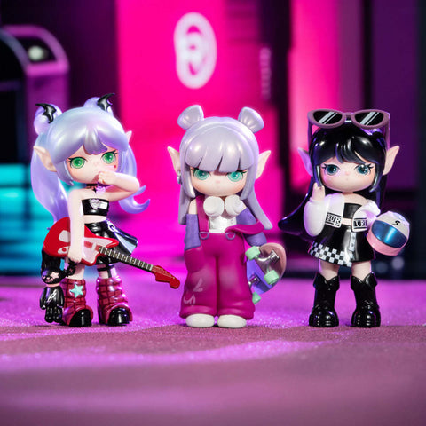 Trio of edgy Suri girls: Bass Girl with guitar and horns, Cool Surfer in purple jumpsuit with skateboard, and Moto Queen in black-and-white outfit holding a helmet, neon pink city lights behind them.