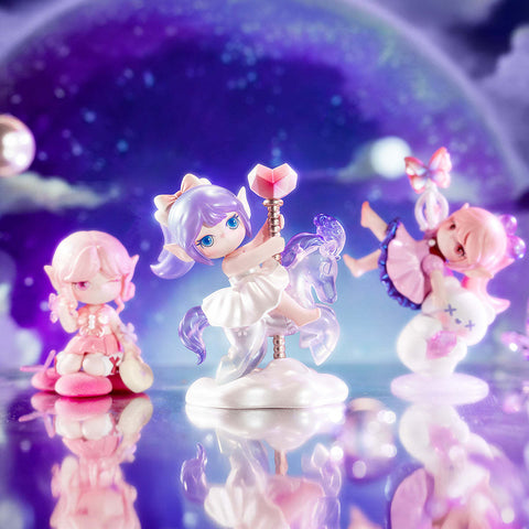 Three Suri Colorful A Girls figures: Pink Princess with pastel hair, Carousel Girl riding a translucent horse pole, and Claw Player with butterfly and plush, set against a dreamy purple backdrop.