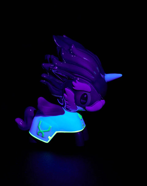 The Heimerdinger Unicorno appears under blacklight, revealing bright UV-reactive yellows, greens, and glowing accents across the mane, goggles, and body markings. Chrome sections pick up cool color reflections, making mechanical engravings and stylized shapes appear sharper under ultraviolet lighting.