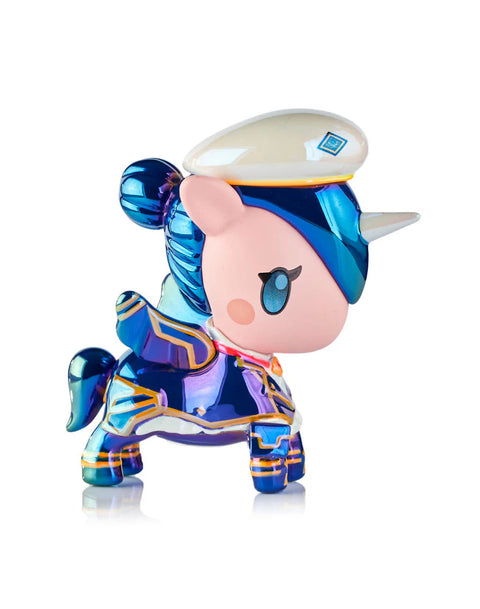 A chrome Unicorno modeled after Caitlyn stands with a glossy navy and metallic-blue uniform, white officer hat, and blue hair gathered into a bun. The bright silver horn and gold accents across the armor reflect light, while the small blue wings match the polished finish of the figure’s body.