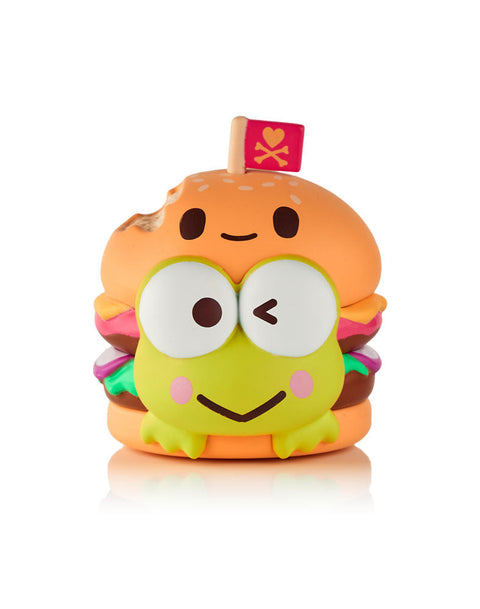 A green Keroppi figure integrated into a cheeseburger design, featuring a sesame seed bun hat with a bite taken out of it and a pink tokidoki heart flag.