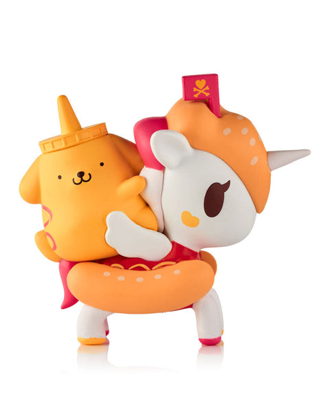 A yellow Pompompurin figure shaped like a mustard bottle with a pointed nozzle, riding atop a "Hot Doggy" Unicorno featuring a bun-textured body, red hot dog saddle, and a pink tokidoki heart flag.