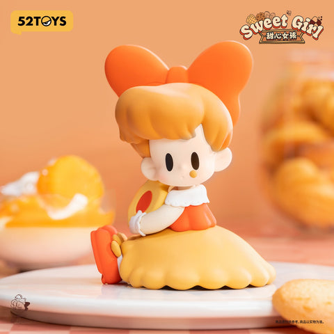 A bright figurine girl with an oversized orange bow, golden skirt, and matching shoes. She sits gracefully holding a citrus cookie, her outfit glowing in cheerful warm tones.