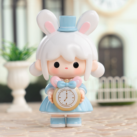A white-haired girl styled with bunny ears and a pastel blue dress wears a tall blue top hat. She holds a golden pocket watch adorned with a pink bow. Inspired by fairy-tale timekeepers, this collectible figure captures magical Alice-in-Wonderland charm with whimsical details and pastel tones.