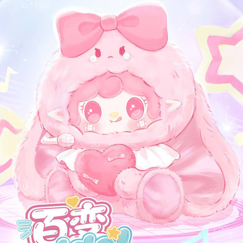 The promotional cover shows a pink plush character with a huge satin bow on its head, sitting on a pastel stage surrounded by glowing music notes and star motifs. The fluffy figure holds a pink heart-shaped pillow and a tiny microphone under soft pink and blue lighting.