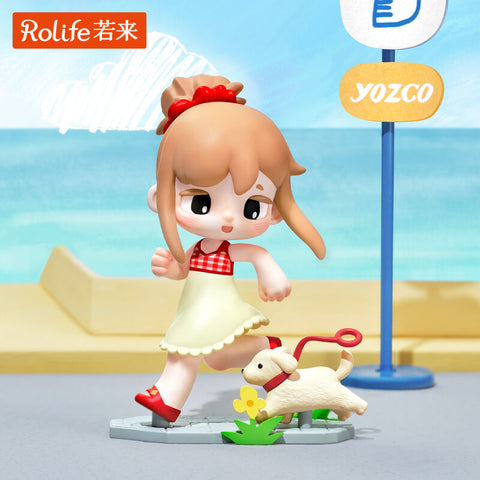 A cheerful girl in a cream dress with a red gingham top runs playfully with her small white puppy on a leash. She stands on a sidewalk base near a bus stop sign, her red shoes and hair bow adding bright accents. The lively sculpt highlights carefree joy and the bond between a girl and her pet.