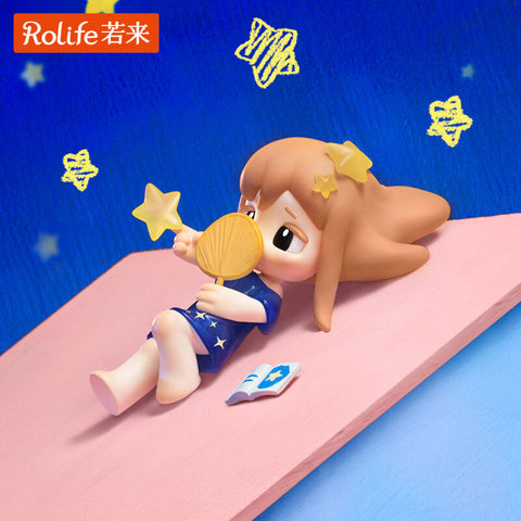A girl lies on her back in a navy nightdress with star patterns, holding a star-shaped fan in one hand while gazing dreamily. Around her float drawn golden stars, with a book by her side. The soft colors and playful details evoke peaceful bedtime imagination and childlike wonder under the sky.