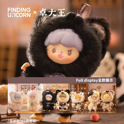A promotional image for the Finding Unicorn x 卓大王 (Zhuo Da Wang) "My Little Cat Series" plush blind box collection. The main focus is a close-up of a plush figure with a cute doll-like face, lavender hair, and a black furry cat costume with ears. Below it is a full display lineup of 7 plush toys, each wearing different cat-themed outfits, shown in a cozy indoor setting. The text includes branding and mentions “Full display 全款展示” with a note about 6 regular and 1 hidden edition.